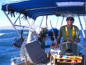 Tim taking charge at the helm. Big swell in the background, but going downwind!