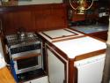 Force 10 stove and fridge; chart table & nav station to the right