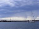 Boat motoring to marina after the wind calmed and the rain is coming!